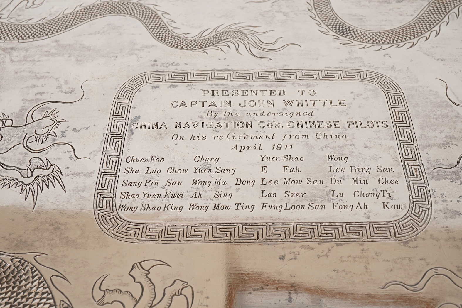 An early 20th century Chinese Export white metal two handled rectangular tea tray, by Luen Wo, Shanghai, with engraved presentation inscription, 'Presented to Captain John Whittle by the undersigned China Navigation Cos.